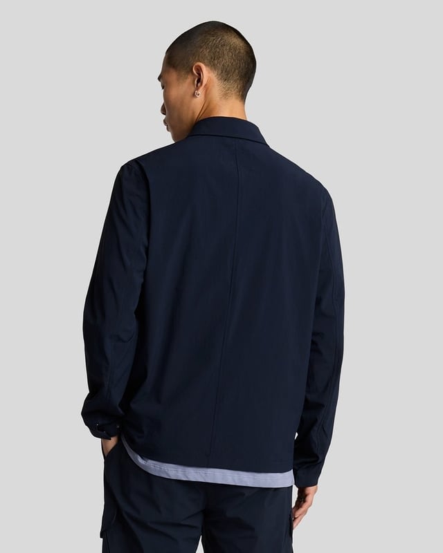 Style, quality and quintessentially British, Lyle & Scott  has over 100 years\' worth of technical expertise going into their products. Traditional garments have been given an injection of contemporary aesthetics but don\'t forget that iconic Golden Eagle logo, you\'re immediately recognised to be wearing a reputable brand.The Pocket Overshirt is an elevated version of a classic overshirt. Crafted from a durable blend of cotton and polyester. Featuring a pointed collar, full zip closure, twin chest pockets and buttoned cuffs. Finished with the iconic Golden Eagle logo embroidery on the chest.Regular Fit, Cotton Poly Blend, Pointed Collar, Full Zip Closure, Twin Chest Pockets, Buttoned Cuffs, Lyle & Scott Branding. Style & Fit:Regular Fit, Fits True to Size. Composition & Care:65% Polyester, 35% Cotton, Machine Wash.