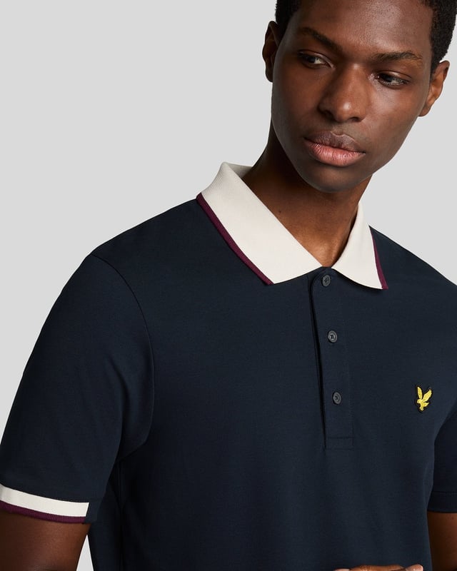Elevate your spring menswear collection with the Half Tipped Polo Shirt, a quintessential piece that merges refinement and casual sophistication. Crafted with a premium blend of 97% cotton and 3% elastane, this shirt features meticulously designed half-tipped cuff sleeves and a stylish tipped collar, complemented by three elegant buttons. Adorned with a golden embroidered eagle on the left chest, it showcases a signature touch of luxury for the modern gentleman.

- Composition: 97% Cotton, 3% Elastane 
- Fit: Regular 
- Logo Branding: Golden embroidered eagle 
- Garment Location: Left chest 
- Styling Versatility: Perfect for both casual outings and refined gatherings 

Indulge in a garment that epitomizes elegance and versatility, making it a must-have addition to any discerning wardrobe this spring.