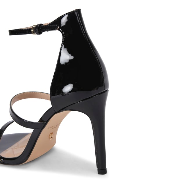 The Kurt Geiger Park Lane heel arrives in a black patent style. The heel is enclosed with gold buckle on the ankle strap as well as small gold branded stud detail at the heel. Heel height: 9.5cm.