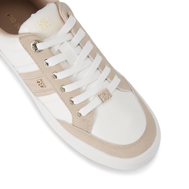 The KG Kurt Geiger Lindsey is a lace up sneaker crafted in taupe and white. There are gold tone branding details seen across the upper.