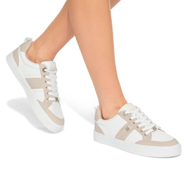 The KG Kurt Geiger Lindsey is a lace up sneaker crafted in taupe and white. There are gold tone branding details seen across the upper.