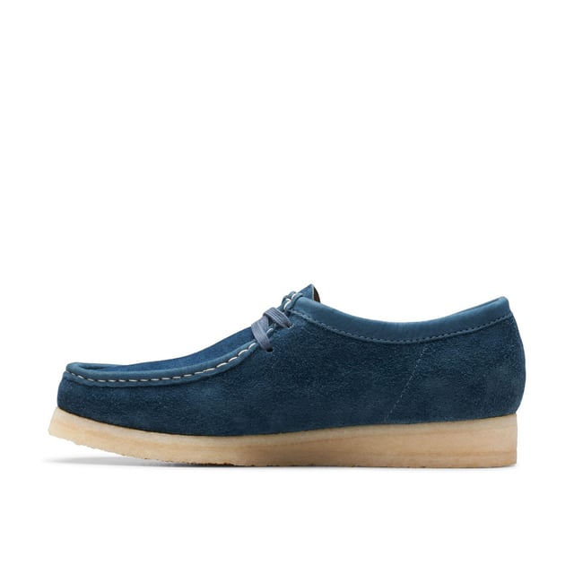 Clean  simple and timeless - our Originals icon is presented in navy and teal to lend a splash of colour to any look. Constructed with an Oasis suede upper from British tannery Charles F Stead  these Wallabees feature a white contrasting stitch on the apron between the vamp and the quarter. Taking you through morning  noon and night  this staple pair will style up every occasion.• CF Stead Oasis navy and teal suede uppers• Includes additional contrasting lace for versatile wear• Natural pebble crepe sole• Clarks Originals heat embossed metallic foil transfer on sock bed• Finished with two Clarks Originals fobs - Clarks Originals and WALLABEES• Moccasin construction