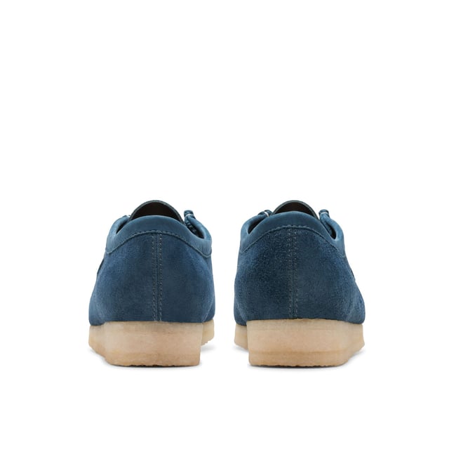 Clean  simple and timeless - our Originals icon is presented in navy and teal to lend a splash of colour to any look. Constructed with an Oasis suede upper from British tannery Charles F Stead  these Wallabees feature a white contrasting stitch on the apron between the vamp and the quarter. Taking you through morning  noon and night  this staple pair will style up every occasion.• CF Stead Oasis navy and teal suede uppers• Includes additional contrasting lace for versatile wear• Natural pebble crepe sole• Clarks Originals heat embossed metallic foil transfer on sock bed• Finished with two Clarks Originals fobs - Clarks Originals and WALLABEES• Moccasin construction