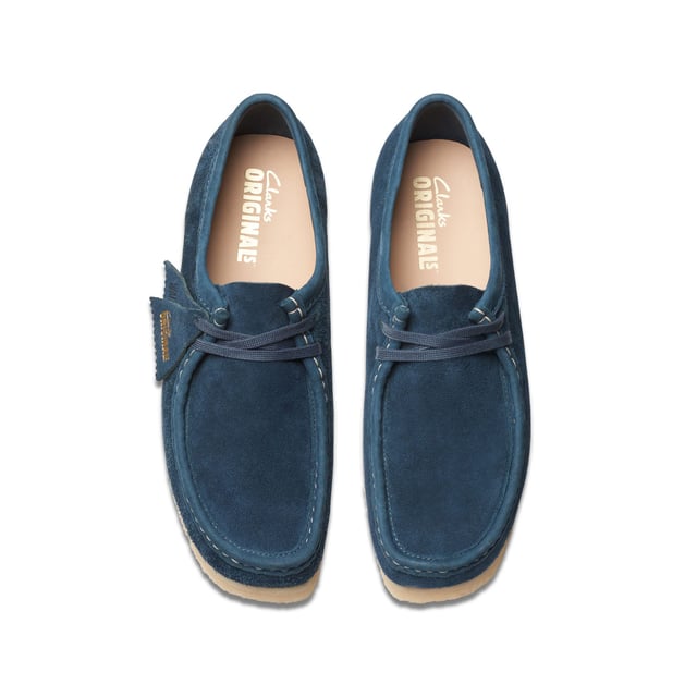 Clean  simple and timeless - our Originals icon is presented in navy and teal to lend a splash of colour to any look. Constructed with an Oasis suede upper from British tannery Charles F Stead  these Wallabees feature a white contrasting stitch on the apron between the vamp and the quarter. Taking you through morning  noon and night  this staple pair will style up every occasion.• CF Stead Oasis navy and teal suede uppers• Includes additional contrasting lace for versatile wear• Natural pebble crepe sole• Clarks Originals heat embossed metallic foil transfer on sock bed• Finished with two Clarks Originals fobs - Clarks Originals and WALLABEES• Moccasin construction
