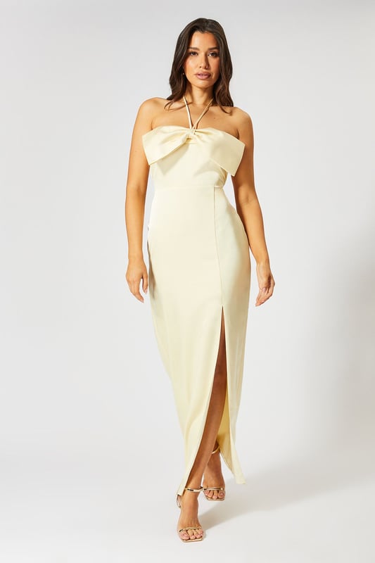 Striking halterneck design with an oversized bow detail for a dramatic entrance
        Luxurious satin fabric that catches the light beautifully as you move
        Figure-flattering maxi silhouette with a daring side slit for ease of movement
        Sleek, streamlined fit that contours to your body's natural shape
        Fully lined for comfort and a flawless drape that maintains its shape throughout wear
    
    Command attention at your next special occasion in this show-stopping satin maxi dress from Misspap. The statement halterneck with oversized bow detail creates a sophisticated yet eye-catching focal point, whilst the sleek column silhouette with side slit offers both elegance and practicality. Style with strappy heeled sandals as seen on our model for a refined evening look, or dress it up further with statement drop earrings and a clutch bag for formal events such as weddings or graduation ceremonies. The clean lines and timeless design make this dress a versatile addition to your occasion wardrobe that can be styled differently each time. Perfect for those moments when you want to feel confident, glamorous and utterly unforgettable - this is a dress designed to turn heads and create lasting impressions.