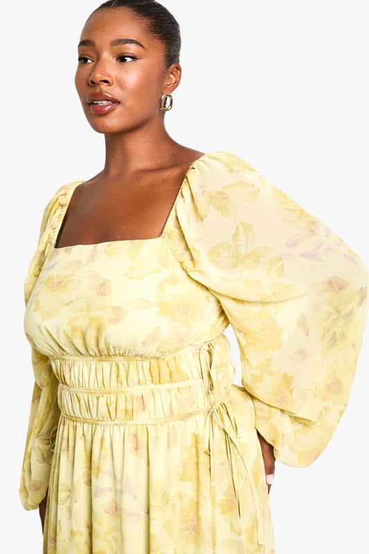 Elegant square neckline for a flattering dcolletage
        Flowing chiffon fabric with all-over pattern creates movement and drama
        Elasticated waist design offers comfortable fit and accentuates curves
        Statement balloon sleeves add contemporary flair to this classic silhouette
        Floor-sweeping maxi length perfect for making an entrance
    
    Make a striking impression in this captivating plus size maxi dress from Boohoo. The square neckline frames your dcolletage beautifully, whilst the elasticated waist creates definition and ensures all-day comfort. The billowing balloon sleeves add a touch of drama that's perfectly balanced by the flowing skirt. Style with strappy heels as seen on our model for an evening look that commands attention, or dress down with flat sandals for daytime sophistication. Add statement earrings and a clutch bag for drinks with the girls, or layer with a cropped jacket when the temperature drops. This versatile piece transitions effortlessly from summer garden parties to autumn evening events - simply adjust your accessories to suit the occasion.