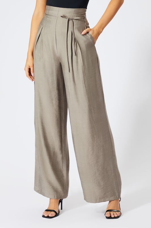 Striking paper bag waist design with self-tie belt for a customisable fit
        Wide leg silhouette creates a dramatic, flowing effect with every step
        High-waisted cut elongates the legs for a flattering profile
        Lightweight linen-look fabric offers breathable comfort for all-day wear
        Side pockets add practical functionality to this fashion-forward piece
    
    These wide leg trousers showcase MissPap's signature blend of comfort and contemporary style. The distinctive paper bag waist creates a gathered effect that cinches in your silhouette, while the flowing wide legs deliver movement and drama. Style them as seen with a one-shoulder bodysuit for casual gatherings, or dress them up with a cropped blouse and strappy heels for evening drinks with the girls. The versatile linen-look fabric transitions effortlessly between seasons-layer with an oversized blazer when temperatures drop or wear alone with a bandeau top during warmer months. Perfect for family brunches, shopping trips with mates, or casual Friday at the office, these trousers offer the ideal balance of relaxed comfort and head-turning style that MissPap devotees adore.
