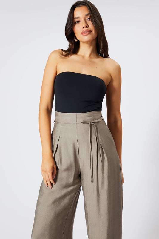 Striking paper bag waist design with self-tie belt for a customisable fit
        Wide leg silhouette creates a dramatic, flowing effect with every step
        High-waisted cut elongates the legs for a flattering profile
        Lightweight linen-look fabric offers breathable comfort for all-day wear
        Side pockets add practical functionality to this fashion-forward piece
    
    These wide leg trousers showcase MissPap's signature blend of comfort and contemporary style. The distinctive paper bag waist creates a gathered effect that cinches in your silhouette, while the flowing wide legs deliver movement and drama. Style them as seen with a one-shoulder bodysuit for casual gatherings, or dress them up with a cropped blouse and strappy heels for evening drinks with the girls. The versatile linen-look fabric transitions effortlessly between seasons-layer with an oversized blazer when temperatures drop or wear alone with a bandeau top during warmer months. Perfect for family brunches, shopping trips with mates, or casual Friday at the office, these trousers offer the ideal balance of relaxed comfort and head-turning style that MissPap devotees adore.