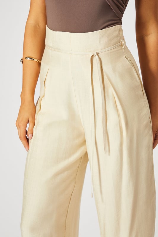 Striking paper bag waist design with self-tie belt for a customisable fit
        Wide leg silhouette creates a dramatic, flowing effect with every step
        High-waisted cut elongates the legs for a flattering profile
        Lightweight linen-look fabric offers breathable comfort for all-day wear
        Side pockets add practical functionality to this fashion-forward piece
    
    These wide leg trousers showcase MissPap's signature blend of comfort and contemporary style. The distinctive paper bag waist creates a gathered effect that cinches in your silhouette, while the flowing wide legs deliver movement and drama. Style them as seen with a one-shoulder bodysuit for casual gatherings, or dress them up with a cropped blouse and strappy heels for evening drinks with the girls. The versatile linen-look fabric transitions effortlessly between seasons-layer with an oversized blazer when temperatures drop or wear alone with a bandeau top during warmer months. Perfect for family brunches, shopping trips with mates, or casual Friday at the office, these trousers offer the ideal balance of relaxed comfort and head-turning style that MissPap devotees adore.