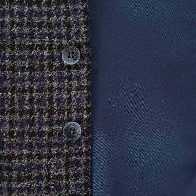 Add heritage charm to your wardrobe with this distinguished Houndstooth Tweed Waistcoat from Hackett London. Crafted in Romania with a meticulous eye for detail, this piece effortlessly blends traditional British tailoring with contemporary flair.

Color: Grey/Multi – featuring a classic houndstooth pattern with subtle color accents for added depth

Material:

Shell: 100% Wool – rich in texture and warmth, perfect for cooler seasons

Lining: 100% Rayon – soft and breathable for comfortable all-day wear

Craftsmanship: Proudly made in Romania with expert tailoring and fine finishing touches

Ideal for layering under a blazer or pairing with chinos for a polished smart-casual look, this waistcoat is a refined staple for the modern gentleman.