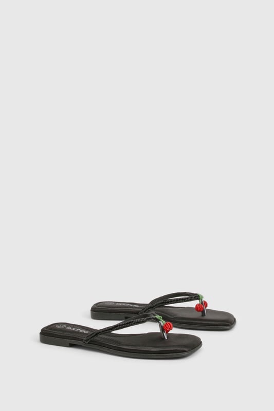 Elegant flip flop sandals featuring charming bead embellishments for a distinctive touch
        Flat heel design (under 2cm) ensures all-day comfort without compromising on style
        Soft satin straps provide a luxurious feel against the skin
        Lightweight thermoplastic sole offers flexibility and durability for extended wear
        Versatile toe-post design perfect for effortless summer styling
    
    These delightful bead-embellished sandals strike the perfect balance between casual comfort and subtle sophistication. The flat design makes them ideal for long summer days when you need footwear that won't slow you down but still want to maintain a stylish appearance. Pair them with cropped linen trousers and a loose-fitting blouse for relaxed weekend brunches, or team with a flowing maxi dress for garden parties and family gatherings. The understated design works brilliantly with both casual daywear and more refined holiday ensembles. These sandals truly come into their own during warmer months, offering a practical yet fashionable option for beach holidays, city breaks, or simply strolling through local markets. Their versatility makes them an essential addition to any summer wardrobe, easily transitioning from daytime casual to evening relaxation.