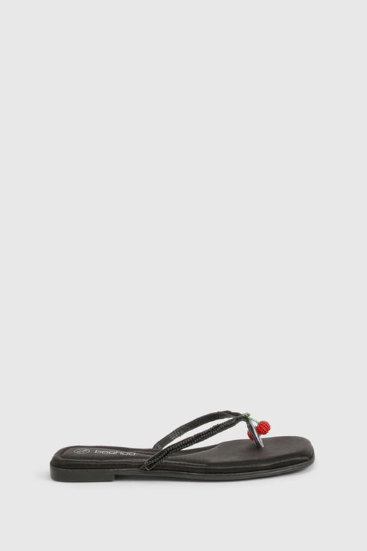 Elegant flip flop sandals featuring charming bead embellishments for a distinctive touch
        Flat heel design (under 2cm) ensures all-day comfort without compromising on style
        Soft satin straps provide a luxurious feel against the skin
        Lightweight thermoplastic sole offers flexibility and durability for extended wear
        Versatile toe-post design perfect for effortless summer styling
    
    These delightful bead-embellished sandals strike the perfect balance between casual comfort and subtle sophistication. The flat design makes them ideal for long summer days when you need footwear that won't slow you down but still want to maintain a stylish appearance. Pair them with cropped linen trousers and a loose-fitting blouse for relaxed weekend brunches, or team with a flowing maxi dress for garden parties and family gatherings. The understated design works brilliantly with both casual daywear and more refined holiday ensembles. These sandals truly come into their own during warmer months, offering a practical yet fashionable option for beach holidays, city breaks, or simply strolling through local markets. Their versatility makes them an essential addition to any summer wardrobe, easily transitioning from daytime casual to evening relaxation.
