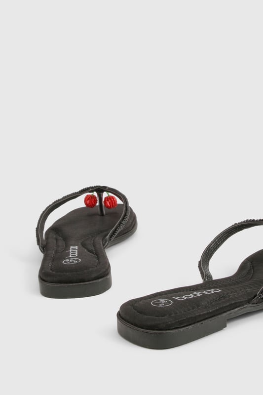 Elegant flip flop sandals featuring charming bead embellishments for a distinctive touch
        Flat heel design (under 2cm) ensures all-day comfort without compromising on style
        Soft satin straps provide a luxurious feel against the skin
        Lightweight thermoplastic sole offers flexibility and durability for extended wear
        Versatile toe-post design perfect for effortless summer styling
    
    These delightful bead-embellished sandals strike the perfect balance between casual comfort and subtle sophistication. The flat design makes them ideal for long summer days when you need footwear that won't slow you down but still want to maintain a stylish appearance. Pair them with cropped linen trousers and a loose-fitting blouse for relaxed weekend brunches, or team with a flowing maxi dress for garden parties and family gatherings. The understated design works brilliantly with both casual daywear and more refined holiday ensembles. These sandals truly come into their own during warmer months, offering a practical yet fashionable option for beach holidays, city breaks, or simply strolling through local markets. Their versatility makes them an essential addition to any summer wardrobe, easily transitioning from daytime casual to evening relaxation.