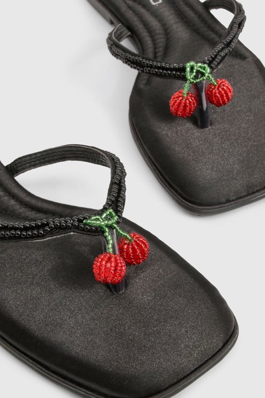 Elegant flip flop sandals featuring charming bead embellishments for a distinctive touch
        Flat heel design (under 2cm) ensures all-day comfort without compromising on style
        Soft satin straps provide a luxurious feel against the skin
        Lightweight thermoplastic sole offers flexibility and durability for extended wear
        Versatile toe-post design perfect for effortless summer styling
    
    These delightful bead-embellished sandals strike the perfect balance between casual comfort and subtle sophistication. The flat design makes them ideal for long summer days when you need footwear that won't slow you down but still want to maintain a stylish appearance. Pair them with cropped linen trousers and a loose-fitting blouse for relaxed weekend brunches, or team with a flowing maxi dress for garden parties and family gatherings. The understated design works brilliantly with both casual daywear and more refined holiday ensembles. These sandals truly come into their own during warmer months, offering a practical yet fashionable option for beach holidays, city breaks, or simply strolling through local markets. Their versatility makes them an essential addition to any summer wardrobe, easily transitioning from daytime casual to evening relaxation.