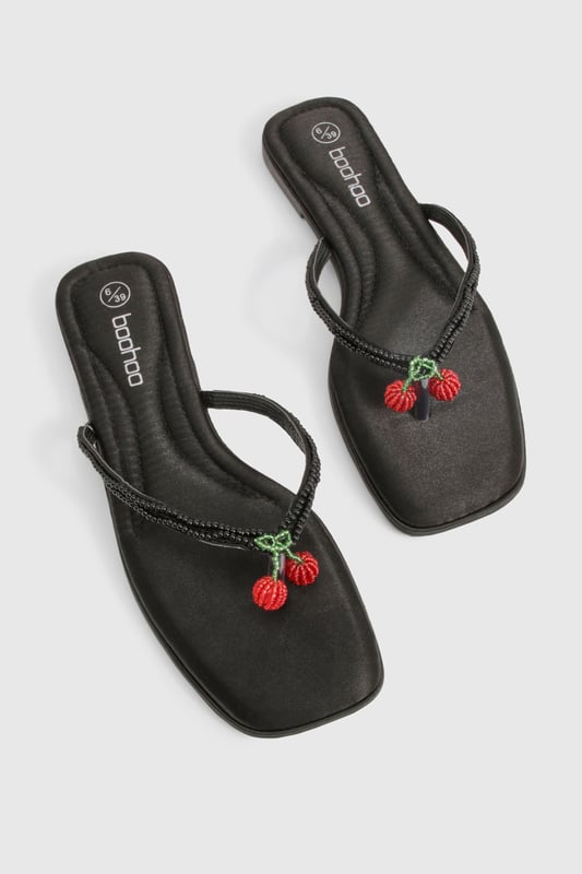 Elegant flip flop sandals featuring charming bead embellishments for a distinctive touch
        Flat heel design (under 2cm) ensures all-day comfort without compromising on style
        Soft satin straps provide a luxurious feel against the skin
        Lightweight thermoplastic sole offers flexibility and durability for extended wear
        Versatile toe-post design perfect for effortless summer styling
    
    These delightful bead-embellished sandals strike the perfect balance between casual comfort and subtle sophistication. The flat design makes them ideal for long summer days when you need footwear that won't slow you down but still want to maintain a stylish appearance. Pair them with cropped linen trousers and a loose-fitting blouse for relaxed weekend brunches, or team with a flowing maxi dress for garden parties and family gatherings. The understated design works brilliantly with both casual daywear and more refined holiday ensembles. These sandals truly come into their own during warmer months, offering a practical yet fashionable option for beach holidays, city breaks, or simply strolling through local markets. Their versatility makes them an essential addition to any summer wardrobe, easily transitioning from daytime casual to evening relaxation.