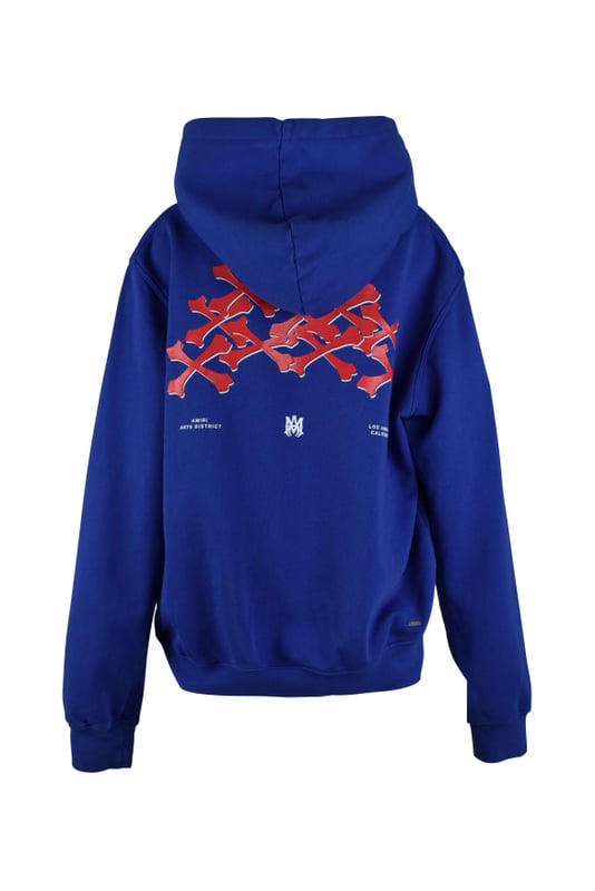 Sudadera con capucha Amiri de algodón azul.Logotipo blanco estampado en el pecho.Estampado de huesos rojo en la espalda.Bordes acanalados.Bolsillo canguro.Made in Italy.