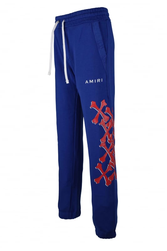 Amiri joggingbroek van blauw katoen.Witte logoprint op de voorkant.Rode botprints langs de pijpen.Elastische tailleband met trekkoorden.Elastische enkels.Zijzakken.Eén achterzak.Zwarte logopatch op de achterkant.Gemaakt in Italië.