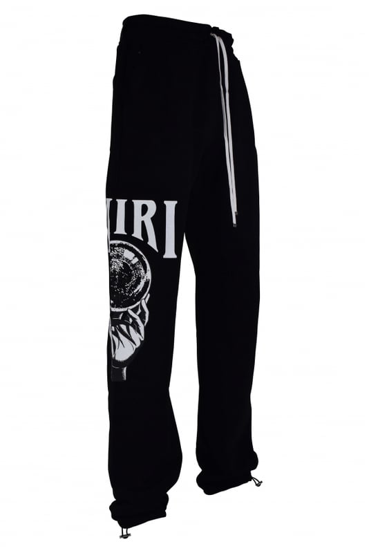 Pantalón jogging Amiri de algodón negro.Estampado gráfico Crystal Ball blanco en una pernera.Cintura elástica con cordones blancos.Logotipo negro en la parte trasera.Bolsillos laterales.Un bolsillo trasero.Tobillos elásticos con cordones.Made in Italy.