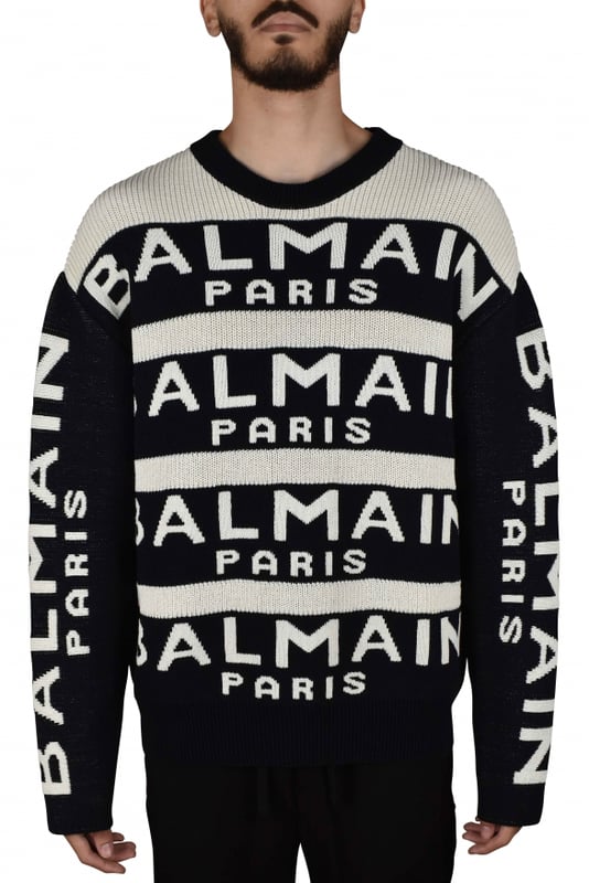 Jersey de lana blanco y negro de Balmain.Rayas negras con logotipo blanco.Mangas largas negras con logotipo blanco.Cuello redondo.Bordes de canalé.64% lana y 36% poliamida.Made in Italy.