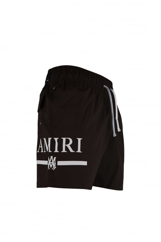 Bañador Amiri marrón de poliéster y elastano.Logotipo blanco de Amiri y MA impreso en el lateral de una pernera.Cintura elástica con cordón.Bolsillos laterales.Un bolsillo trasero con cierre de velcro.Parche negro con el logotipo en la espalda.