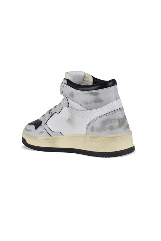 Super Vintage Mid Autry sneakers in wit, grijs en zwart leer.Logopatch aan de buitenkant. Grijze lederen toonbank.Tong met logopatch.Rubberen zool met vintage-effect.  Vetersluiting. Geperforeerde ronde neus.Vergeeld en versleten effect.100% leer.