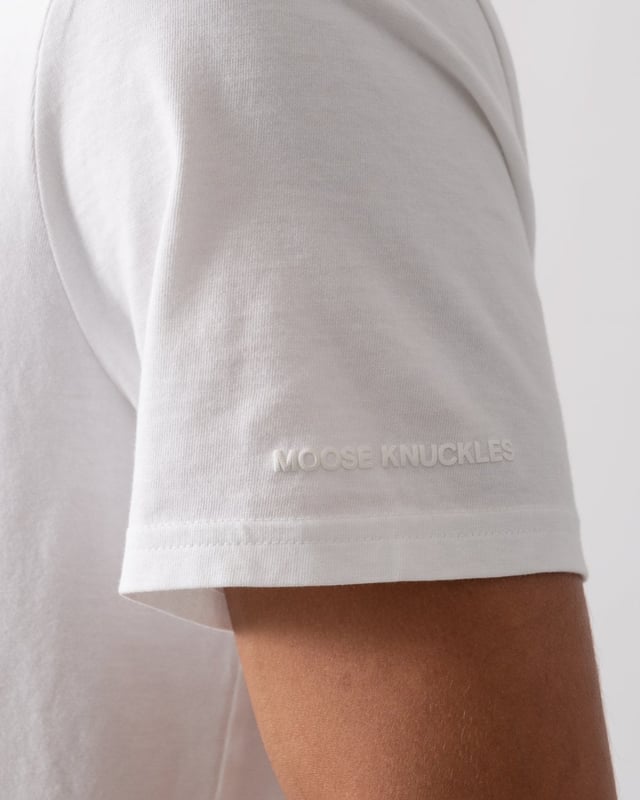 This t-shirt keeps it minimal with tiny branding at the front, offering a clean and understated look.


Regular Fit
Rib Knit Collar
Triangle Patch with Gun Metal Logo
Moose Knuckles Label on Side Seam



100% Pima Cotton Jersey
M15MT777