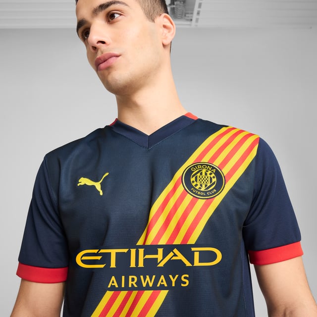 PRODUCT STORY: Gear up and show your allegiance to Girona FC with the official 24/25 Away Jersey. It features mesh panels and moisture-wicking dryCELL tech to keep you feeling cool and comfortable. FEATURES & BENEFITS: dryCELL: Performance technology designed to wick moisture from the body and keep you free of sweat during exercise; As part of the RE:FIBRE program, this garment is made of at least 95% recycled material from textile waste and other used materials. DETAILS: Regular fit; 170 gsm, Jacquard; Mesh inserts; V-neck; Short sleeves; Official team branding.  Our model is 183 cm tall and is wearing size M UK.