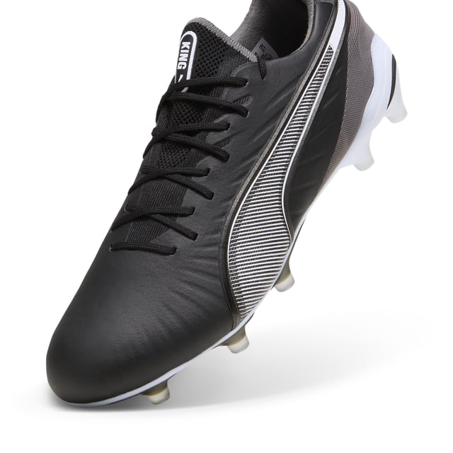 PUMA Unisex KING ULTIMATE FG/AG Football Boots PRODUCT STORY: Let everyone know: there’s a new KING in town. This football boot lives up to its name with the combination of non-animal-based K-BETTER™ upper material and GRIPCONTROL 3D structure on the medial side for enhanced ball control. A new KING doesn’t come along every day, but there will always be a new KING. The rightful heir is here. FEATURES & BENEFITS: TOUCH: Non-animal-based K-BETTER™ upper material for a new and improved take on the signature KING touch, comfort, and durability; CONTROL: GRIPCONTROL 3D rib structure on the medial side with grippy print for enhanced ball control; COMFORT: ORTHOLITE® memory foam padding in the heel for improved comfort; The upper of this shoe is made with at least 30% recycled materials. DETAILS: K-BETTER™ upper; Lightweight removable sockliner with NanoGrip technology to keep the foot from slipping inside the boot; OrthoLite® memory foam padding in the heel for improved comfort; Lightweight outsole with external heel counter, integrated stability spine, and conical studs for maximum manoeuvrability; Regular fit; Knitted low-cut slip-on construction ensures a comfortable fit; FG/AG: Suitable for use on firm or artificial surfaces; 84.66% Synthetic, 15.34% Textile.