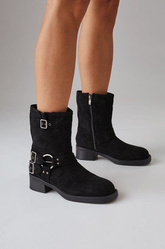 Faux suede chunky biker calf boots
        Mid-heel height between 5 and 6.5cm
        Decorative buckle and strap detailing
        Side zip closure for easy wear
        Sturdy block heel for comfort and stability
    
    Step out in style with these Faith Eostre faux suede chunky biker calf boots. The edgy design combines comfort and fashion, making them perfect for various casual outings. The mid-heel height offers a subtle lift without compromising on wearability, ideal for all-day adventures. Style these versatile boots with a flowy mini skirt and an oversized jumper for a chic autumn look, or pair them with skinny jeans and a leather jacket for a classic biker-inspired ensemble. These boots are your go-to choice for family gatherings, weekend brunches, or casual shopping trips. Their robust construction and timeless appeal ensure they'll be a staple in your wardrobe for seasons to come, effortlessly transitioning from day to night with their adaptable style.