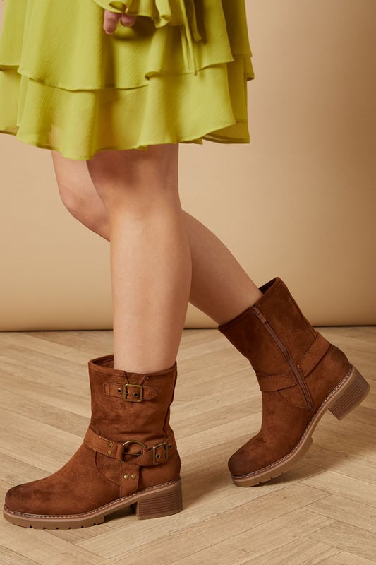 Chunky biker-inspired calf boots
        Faux suede material for a luxe look
        Decorative buckle detailing
        Mid-heel height between 5 and 6.5cm
        Side zip closure for easy on and off
    
    Step out in style with these Lila Faux Suede Chunky Biker Calf Boots from Oasis. These versatile boots blend edgy biker aesthetics with feminine charm, making them perfect for various casual occasions. The mid-heel height offers comfort without sacrificing style, ideal for all-day wear. Pair them with a flowy dress, as seen on our model, for a beautiful contrast between soft and tough elements. These boots are equally at home with skinny jeans and a leather jacket for a more rugged look, or with a midi skirt and cosy jumper for a chic autumn ensemble. Whether you're heading to a family gathering, enjoying a day out shopping, or meeting friends for a casual lunch, these boots will keep you looking fashionable and feeling comfortable.