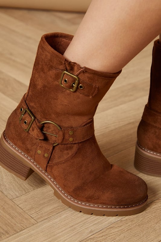Chunky biker-inspired calf boots
        Faux suede material for a luxe look
        Decorative buckle detailing
        Mid-heel height between 5 and 6.5cm
        Side zip closure for easy on and off
    
    Step out in style with these Lila Faux Suede Chunky Biker Calf Boots from Oasis. These versatile boots blend edgy biker aesthetics with feminine charm, making them perfect for various casual occasions. The mid-heel height offers comfort without sacrificing style, ideal for all-day wear. Pair them with a flowy dress, as seen on our model, for a beautiful contrast between soft and tough elements. These boots are equally at home with skinny jeans and a leather jacket for a more rugged look, or with a midi skirt and cosy jumper for a chic autumn ensemble. Whether you're heading to a family gathering, enjoying a day out shopping, or meeting friends for a casual lunch, these boots will keep you looking fashionable and feeling comfortable.