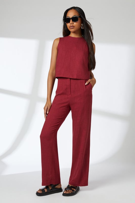 Sleeveless cropped top with elegant round neckline
        Linen blend fabric offers breathable comfort with natural texture
        Versatile V-back design with visible zip closure
        Practical side pockets in the coordinating wide-leg trousers
        Relaxed silhouette perfect for effortless day-to-night styling
    
    This Principles linen blend cropped top combines comfort with contemporary style for your warm-weather wardrobe. The clean lines and minimalist design create a refined silhouette that pairs beautifully with the matching wide-leg trousers for an effortlessly coordinated look. Style with leopard print sandals and statement hoop earrings as shown for casual daytime outings, or dress up with metallic accessories for alfresco dining. The breathable fabric makes it ideal for family gatherings and weekend brunches, while the versatile design transitions seamlessly from city breaks to coastal holidays. Layer with a lightweight cardigan when the temperature drops, or pair the top with tailored denim for a smart-casual alternative that showcases its versatility.