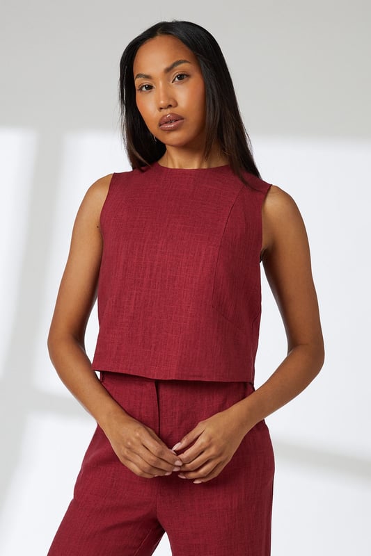 Sleeveless cropped top with elegant round neckline
        Linen blend fabric offers breathable comfort with natural texture
        Versatile V-back design with visible zip closure
        Practical side pockets in the coordinating wide-leg trousers
        Relaxed silhouette perfect for effortless day-to-night styling
    
    This Principles linen blend cropped top combines comfort with contemporary style for your warm-weather wardrobe. The clean lines and minimalist design create a refined silhouette that pairs beautifully with the matching wide-leg trousers for an effortlessly coordinated look. Style with leopard print sandals and statement hoop earrings as shown for casual daytime outings, or dress up with metallic accessories for alfresco dining. The breathable fabric makes it ideal for family gatherings and weekend brunches, while the versatile design transitions seamlessly from city breaks to coastal holidays. Layer with a lightweight cardigan when the temperature drops, or pair the top with tailored denim for a smart-casual alternative that showcases its versatility.