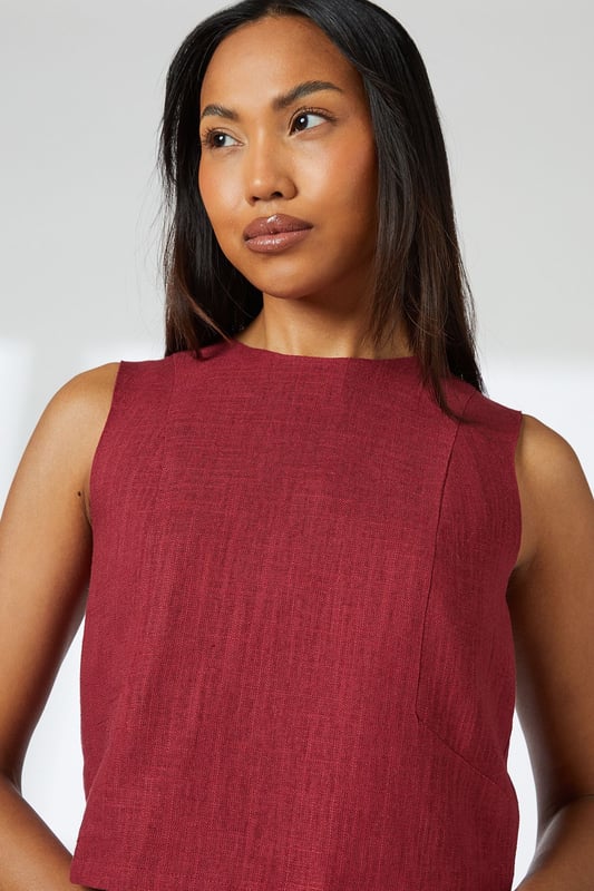 Sleeveless cropped top with elegant round neckline
        Linen blend fabric offers breathable comfort with natural texture
        Versatile V-back design with visible zip closure
        Practical side pockets in the coordinating wide-leg trousers
        Relaxed silhouette perfect for effortless day-to-night styling
    
    This Principles linen blend cropped top combines comfort with contemporary style for your warm-weather wardrobe. The clean lines and minimalist design create a refined silhouette that pairs beautifully with the matching wide-leg trousers for an effortlessly coordinated look. Style with leopard print sandals and statement hoop earrings as shown for casual daytime outings, or dress up with metallic accessories for alfresco dining. The breathable fabric makes it ideal for family gatherings and weekend brunches, while the versatile design transitions seamlessly from city breaks to coastal holidays. Layer with a lightweight cardigan when the temperature drops, or pair the top with tailored denim for a smart-casual alternative that showcases its versatility.