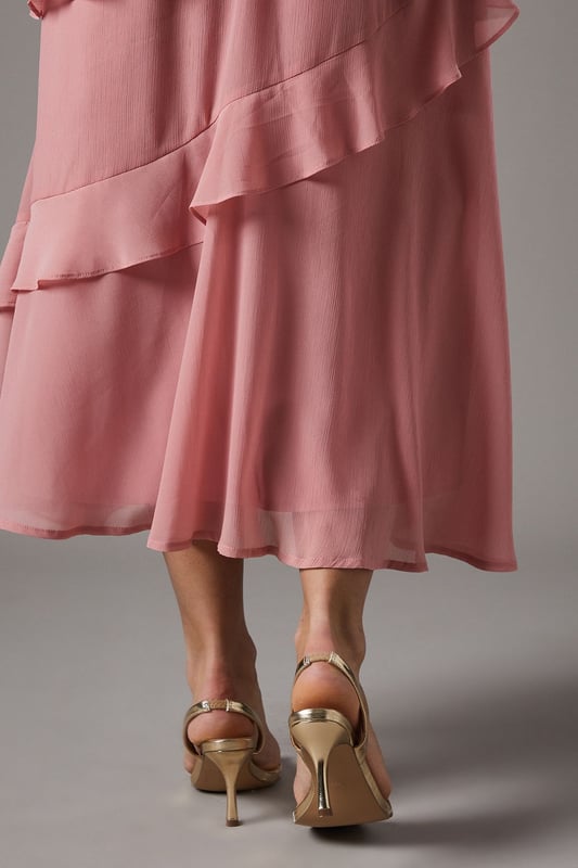 Elegant sling back design with delicate barely-there straps for a sophisticated silhouette
        Medium heel height of 5-6.5cm offers the perfect balance of comfort and style
        Sleek metallic finish that catches the light beautifully with every step
        Secure adjustable sling back strap ensures a comfortable, customised fit
        Versatile design that complements both daytime and evening occasion wear
    
    The Vallen Sling Back Sandals from Coast present the quintessential occasion footwear for the discerning woman. These medium-heeled sandals feature a minimalist barely-there design that showcases the foot beautifully whilst providing elegant support. The metallic finish adds a touch of glamour that pairs wonderfully with flowing dresses, as shown with the layered chiffon dress in the imagery. Perfect for weddings, race days and formal gatherings where sophistication is paramount, these sandals will carry you through the day with grace. Style with a structured clutch bag and delicate jewellery for a coordinated ensemble. The modest heel height ensures you can dance the night away or stand comfortably throughout day-long events without compromising on style. These versatile sandals will become a treasured addition to your occasion wardrobe for seasons to come.