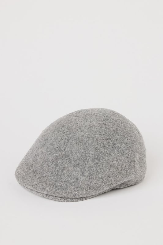 Crafted with wool for exceptional warmth and comfort
        Brushed texture adds subtle sophistication to the classic flat cap design
        Streamlined silhouette with a structured shape that maintains its form
        Versatile one-size design suitable for everyday wear
        Discreet side vent detail for improved fit and comfort
    
    This timeless flat cap from Burton brings traditional British style to your casual wardrobe. The brushed finish creates a refined texture that pairs brilliantly with autumn and winter outfits. Style with a classic button-up shirt and chinos for weekend pub lunches, or throw on with a casual jumper and jeans for sporting events. The neutral grey tone makes this cap exceptionally versatile, complementing both country walks and city outings with equal measure. For cooler days, layer with a wool overcoat and Chelsea boots for a distinguished look that balances comfort and style. This flat cap offers that perfect finishing touch to elevate your casual ensembles without appearing overly formal - an essential accessory for the modern British gent who appreciates heritage-inspired fashion.