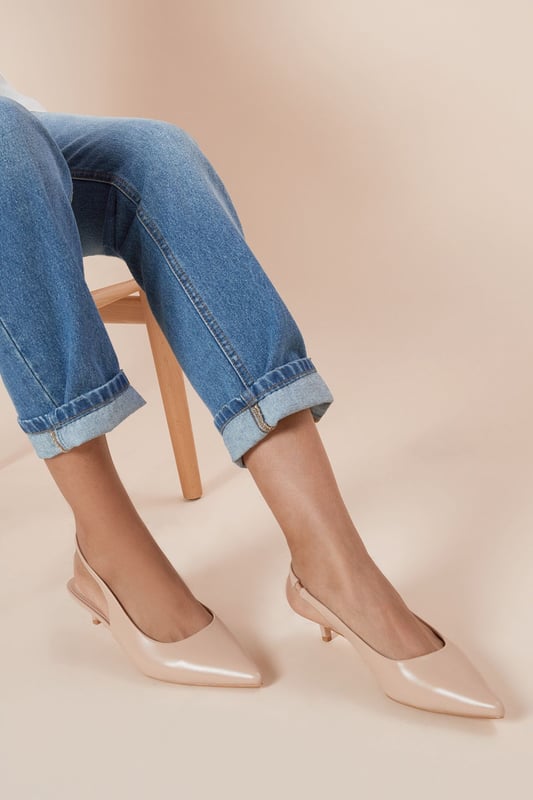 Chic slingback design for easy slip-on and off
        Pointed toe silhouette for a sleek, feminine look
        Comfortable kitten heel measuring between 2.5 and 4.5cm
        Versatile faux leather material suitable for various occasions
        Adjustable slingback strap for a customised fit
    
    Step out in style with the Faelina Faux Leather Slingback Kitten Heel Court Shoes from Dorothy Perkins. These elegant shoes strike the perfect balance between comfort and sophistication, making them ideal for the modern woman on the go. The low kitten heel provides just enough lift without compromising on comfort, allowing you to confidently navigate your day from brunch with friends to family gatherings. Pair these versatile court shoes with cropped jeans and a flowy blouse for a casual yet put-together look, or dress them up with a midi skirt and statement top for those special daytime events. The neutral hue ensures these shoes will complement a variety of outfits in your wardrobe, while the pointed toe adds a touch of refinement to any ensemble. Whether you're attending a baby shower or meeting colleagues for a casual lunch, these Faelina slingbacks will keep you stylish and comfortable throughout your busy day.
