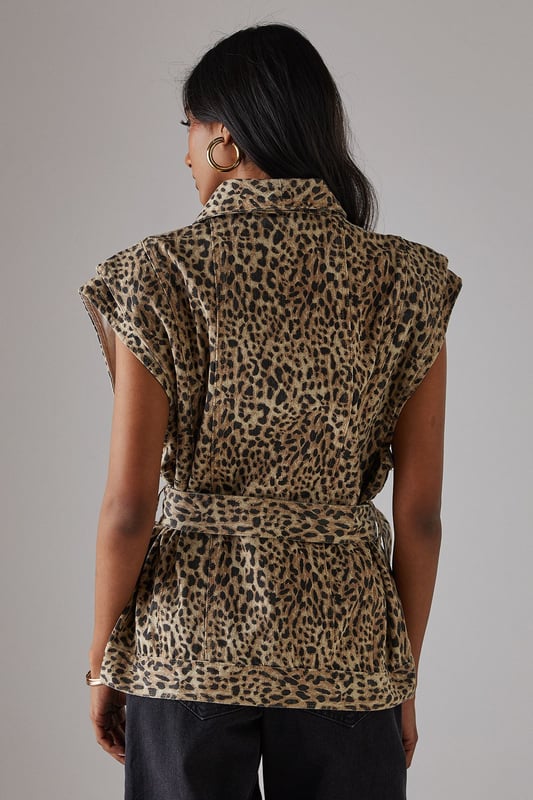 Sleeveless denim jacket with bold leopard print
        Funnel neck for a contemporary edge
        Boxy fit offering a modern silhouette
        Belted waist for a flattering, adjustable fit
        Button-through front for versatile styling options
    
    Make a statement with this eye-catching leopard print sleeveless denim jacket from Warehouse. The boxy fit and funnel neck create a contemporary silhouette that's perfect for the confident, fashion-forward woman. The belted waist allows for a customised fit, accentuating your figure while maintaining a relaxed feel. Ideal for casual events and family gatherings, this versatile piece can be styled in numerous ways. Layer it over a simple black tee and wide-leg trousers for a chic daytime look, or button it up and wear as a standalone top with your favourite jeans for an edgy evening ensemble. The sleeveless design makes it a great transitional piece, easily paired with long-sleeved tops for cooler days. Finish the look with gold hoop earrings and ankle boots to channel effortless urban style.