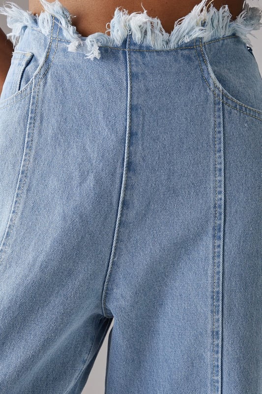 Wide leg silhouette with distinctive fray detailing at waistband and hem for an edgy finish
        Front seam detailing adds architectural interest and elongates the leg
        Cotton fabric provides comfort and breathability for all-day wear
        Practical side and back pockets for everyday functionality
        High-rise waist creates a flattering silhouette that pairs perfectly with cropped tops
    
    These Warehouse wide leg jeans combine contemporary design with effortless wearability. The striking fray detail along the waistband and hem creates a raw, fashion-forward aesthetic that sets these jeans apart from standard denim styles. Style them as shown with a simple fitted vest top for casual daytime outings, or dress them up with a tucked-in blouse and statement jewellery for lunch with friends. The cotton fabric ensures these jeans move comfortably with you throughout the day, while the front seam detailing creates a leg-lengthening effect. Perfect for weekend brunches, gallery visits or casual shopping trips, these jeans offer versatility without compromising on style. Complete the look with flat loafers or trainers for an understated daytime ensemble, or add a structured jacket for a more polished finish.
