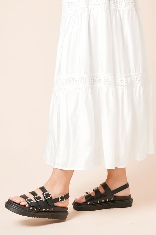 Faux leather construction for a sleek, animal-friendly design
        Triple buckle detailing for an edgy, adjustable fit
        Chunky footbed provides comfort and a trendy silhouette
        Slingback style for easy on-and-off wear
        Flat heel (0-2cm) ensures all-day comfort
    
    Step into style and comfort with the Faith Maelora sandals. These striking slingbacks blend urban edge with practical design, making them a versatile addition to your wardrobe. The triple buckle detailing adds a touch of punk-inspired flair, while the chunky footbed offers both visual interest and cushioned support for your feet. Perfect for casual outings, these sandals can effortlessly complement a variety of looks. Pair them with a flowing maxi dress for a bohemian-chic ensemble, or team them with cropped jeans and a graphic tee for a cool, laid-back vibe. Whether you're strolling through city streets or meeting friends for a relaxed brunch, these Faith sandals will keep you looking fashionable and feeling comfortable all day long.