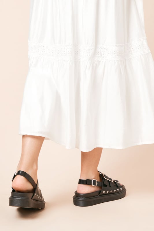 Faux leather construction for a sleek, animal-friendly design
        Triple buckle detailing for an edgy, adjustable fit
        Chunky footbed provides comfort and a trendy silhouette
        Slingback style for easy on-and-off wear
        Flat heel (0-2cm) ensures all-day comfort
    
    Step into style and comfort with the Faith Maelora sandals. These striking slingbacks blend urban edge with practical design, making them a versatile addition to your wardrobe. The triple buckle detailing adds a touch of punk-inspired flair, while the chunky footbed offers both visual interest and cushioned support for your feet. Perfect for casual outings, these sandals can effortlessly complement a variety of looks. Pair them with a flowing maxi dress for a bohemian-chic ensemble, or team them with cropped jeans and a graphic tee for a cool, laid-back vibe. Whether you're strolling through city streets or meeting friends for a relaxed brunch, these Faith sandals will keep you looking fashionable and feeling comfortable all day long.