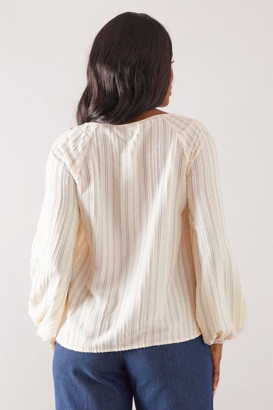 Elegant striped woven top with delicate embroidery detail throughout
        Feminine tie-front closure with keyhole neckline for a sophisticated touch
        Flattering gathered neckline creating a soft, flowing silhouette
        Voluminous balloon sleeves with elasticated cuffs for comfort and style
        Relaxed fit design with a curved hem for versatile styling options
    
    This charming Wallis top combines comfort with effortless sophistication. The gathered neckline and balloon sleeves create a flattering silhouette that works beautifully for daytime occasions. Style with wide-leg denim trousers and sandals, as shown, for family lunches or casual gatherings. The embroidered stripe pattern adds texture and interest, making this piece stand out from basic tops in your collection. For cooler days, layer under a lightweight cardigan or denim jacket. The tie-front detail allows you to adjust the neckline to your preference, while the relaxed fit ensures all-day comfort without compromising on style. Perfect for weekend brunches, shopping trips or casual meet-ups with friends when you want to look polished yet feel comfortable.