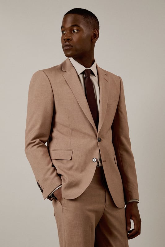 Textured woven fabric adds subtle depth and visual interest to this slim fit jacket
        Notched lapels and two-button fastening create a classic silhouette
        Flap pockets provide practical storage whilst maintaining clean lines
        Slim fit design contours to the body for a modern, defined shape
        Single back vent ensures ease of movement and maintains the jacket's tailored appearance
    
    This Burton suit jacket combines timeless design with contemporary tailoring for the modern gentleman. The slim fit is cut to define your shoulders and chest while tapering at the waist for a sharp silhouette that's both flattering and comfortable. Style with the matching trousers as shown, paired with a crisp white shirt and burgundy tie for formal occasions or business meetings. For smart casual events, dress down with a quality knit and dark jeans. The versatile hue works brilliantly year-round and transitions seamlessly from daytime meetings to evening gatherings. Perfect for those who appreciate classic style with a refined edge, this jacket will become a cornerstone of your smart wardrobe, ideal for everything from important presentations to sophisticated social events at the local pub.