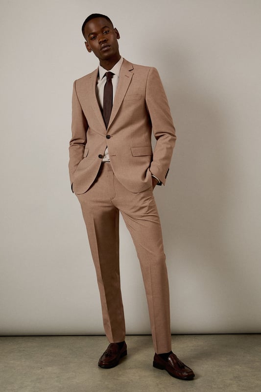 Textured woven fabric adds subtle depth and visual interest to this slim fit jacket
        Notched lapels and two-button fastening create a classic silhouette
        Flap pockets provide practical storage whilst maintaining clean lines
        Slim fit design contours to the body for a modern, defined shape
        Single back vent ensures ease of movement and maintains the jacket's tailored appearance
    
    This Burton suit jacket combines timeless design with contemporary tailoring for the modern gentleman. The slim fit is cut to define your shoulders and chest while tapering at the waist for a sharp silhouette that's both flattering and comfortable. Style with the matching trousers as shown, paired with a crisp white shirt and burgundy tie for formal occasions or business meetings. For smart casual events, dress down with a quality knit and dark jeans. The versatile hue works brilliantly year-round and transitions seamlessly from daytime meetings to evening gatherings. Perfect for those who appreciate classic style with a refined edge, this jacket will become a cornerstone of your smart wardrobe, ideal for everything from important presentations to sophisticated social events at the local pub.