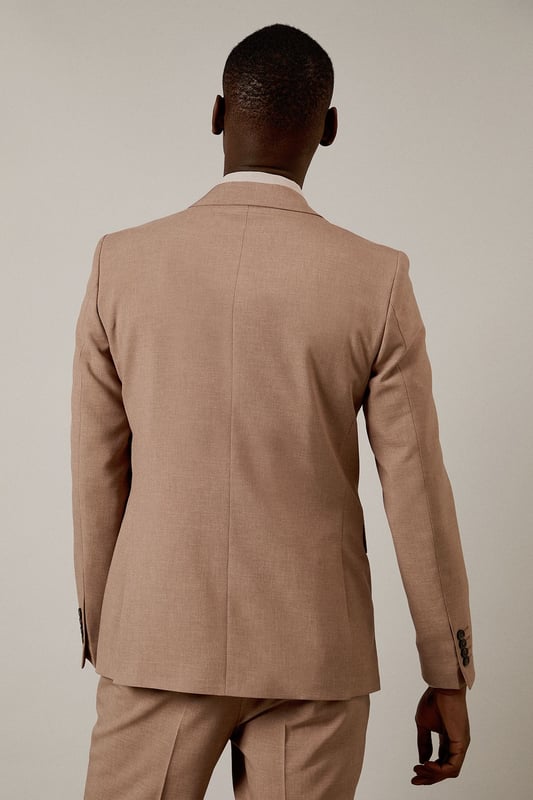 Textured woven fabric adds subtle depth and visual interest to this slim fit jacket
        Notched lapels and two-button fastening create a classic silhouette
        Flap pockets provide practical storage whilst maintaining clean lines
        Slim fit design contours to the body for a modern, defined shape
        Single back vent ensures ease of movement and maintains the jacket's tailored appearance
    
    This Burton suit jacket combines timeless design with contemporary tailoring for the modern gentleman. The slim fit is cut to define your shoulders and chest while tapering at the waist for a sharp silhouette that's both flattering and comfortable. Style with the matching trousers as shown, paired with a crisp white shirt and burgundy tie for formal occasions or business meetings. For smart casual events, dress down with a quality knit and dark jeans. The versatile hue works brilliantly year-round and transitions seamlessly from daytime meetings to evening gatherings. Perfect for those who appreciate classic style with a refined edge, this jacket will become a cornerstone of your smart wardrobe, ideal for everything from important presentations to sophisticated social events at the local pub.