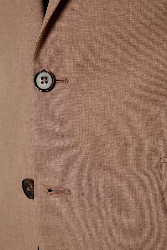 Textured woven fabric adds subtle depth and visual interest to this slim fit jacket
        Notched lapels and two-button fastening create a classic silhouette
        Flap pockets provide practical storage whilst maintaining clean lines
        Slim fit design contours to the body for a modern, defined shape
        Single back vent ensures ease of movement and maintains the jacket's tailored appearance
    
    This Burton suit jacket combines timeless design with contemporary tailoring for the modern gentleman. The slim fit is cut to define your shoulders and chest while tapering at the waist for a sharp silhouette that's both flattering and comfortable. Style with the matching trousers as shown, paired with a crisp white shirt and burgundy tie for formal occasions or business meetings. For smart casual events, dress down with a quality knit and dark jeans. The versatile hue works brilliantly year-round and transitions seamlessly from daytime meetings to evening gatherings. Perfect for those who appreciate classic style with a refined edge, this jacket will become a cornerstone of your smart wardrobe, ideal for everything from important presentations to sophisticated social events at the local pub.