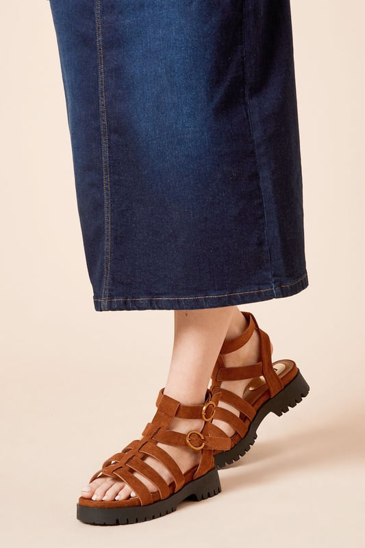 Faux suede T-bar design for a classic look
        Chunky sole adds a modern edge
        Adjustable ankle strap for a secure fit
        Flat heel between 0 and 2cm for all-day comfort
        Versatile sandal suitable for various casual occasions
    
    The Larchlyn Faux Suede T Bar Chunky Sandals from Oasis present a perfect blend of timeless style and contemporary flair. These sandals showcase a classic T-bar design, reimagined with a chunky sole that adds a touch of edginess to your look. The adjustable ankle strap ensures a secure and customised fit, while the flat heel provides comfort for extended wear. Pair these versatile sandals with a flowing white dress for a breezy summer ensemble, or style them with cropped trousers and a lightweight blouse for a chic daytime outfit. Ideal for casual outings, family gatherings, or leisurely strolls, these sandals will quickly become your go-to footwear for effortless, feminine style. The faux suede finish adds a luxurious touch, making these sandals a standout choice for the fashion-conscious woman who values both style and comfort in her everyday wardrobe.