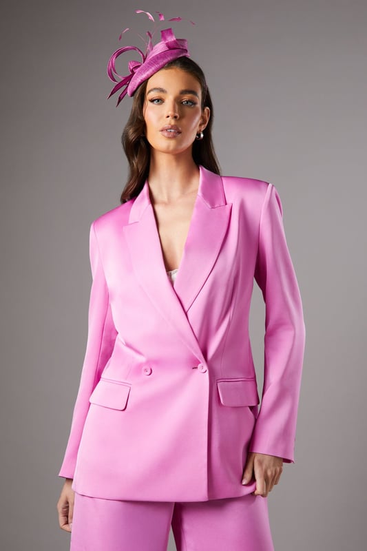 Luxurious satin finish that catches the light beautifully for special occasions
        Elegant double-breasted design with sophisticated button detailing
        Structured notch lapel adds a refined tailoring element
        Practical side pockets perfect for essentials
        Flattering silhouette with subtle stretch for comfortable all-day wear
    
    Make a striking impression at your next formal event with this stunning satin blazer from Coast. The double-breasted design creates a commanding silhouette that embodies confidence and sophistication. Style as seen with coordinating wide-leg trousers and a statement fascinator for race day glamour, or pair with a sleek pencil skirt for wedding guest perfection. The lustrous fabric reflects light beautifully, ensuring you stand out for all the right reasons. For evening affairs, try wearing over a delicate camisole with tailored trousers and pointed court shoes. The versatile design transitions seamlessly from daytime occasions to evening soires, making it a wardrobe investment that delivers time and again. The subtle stretch in the fabric ensures comfort without compromising on structure, allowing you to maintain poise throughout your special event.