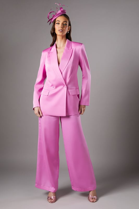 Luxurious satin finish that catches the light beautifully for special occasions
        Elegant double-breasted design with sophisticated button detailing
        Structured notch lapel adds a refined tailoring element
        Practical side pockets perfect for essentials
        Flattering silhouette with subtle stretch for comfortable all-day wear
    
    Make a striking impression at your next formal event with this stunning satin blazer from Coast. The double-breasted design creates a commanding silhouette that embodies confidence and sophistication. Style as seen with coordinating wide-leg trousers and a statement fascinator for race day glamour, or pair with a sleek pencil skirt for wedding guest perfection. The lustrous fabric reflects light beautifully, ensuring you stand out for all the right reasons. For evening affairs, try wearing over a delicate camisole with tailored trousers and pointed court shoes. The versatile design transitions seamlessly from daytime occasions to evening soires, making it a wardrobe investment that delivers time and again. The subtle stretch in the fabric ensures comfort without compromising on structure, allowing you to maintain poise throughout your special event.