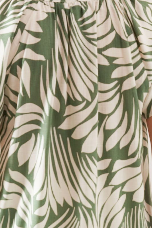 Distinctive collarless design with elegant V-neckline for a sophisticated silhouette
        Unique tie sleeve detail adding a touch of feminine charm to this woven top
        Relaxed fit through the body for all-day comfort and effortless movement
        Versatile abstract print that makes a statement whilst remaining wonderfully wearable
        Short sleeves with decorative ties that create a graceful drape effect
    
    This captivating collarless top from Wallis combines comfort with sophisticated style. The eye-catching abstract print creates visual interest whilst the tie sleeve detail adds a touch of feminine flair to your daywear collection. Style with a belted cream midi skirt and leather sandals for a refined lunch date look, or pair with tailored trousers and ballet flats for family gatherings. The V-neckline frames the dcolletage beautifully, making it perfect for showcasing delicate jewellery. The viscose-blend fabric offers a lovely drape that flatters the figure without clinging. This versatile piece transitions seamlessly from casual coffee mornings to afternoon garden parties, making it an essential addition to your wardrobe that works across multiple seasons.